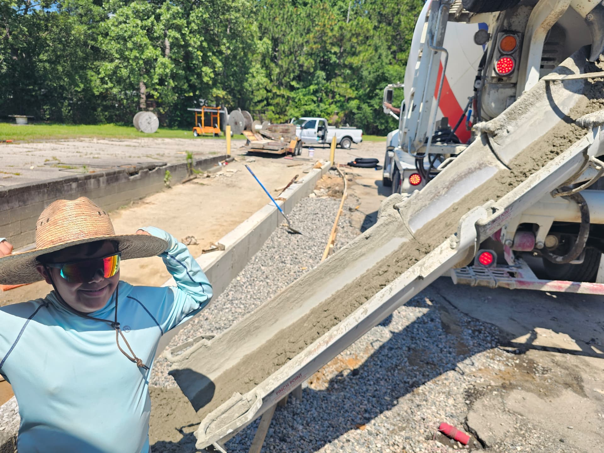Alpha Concrete crew member guiding the chute during a pour