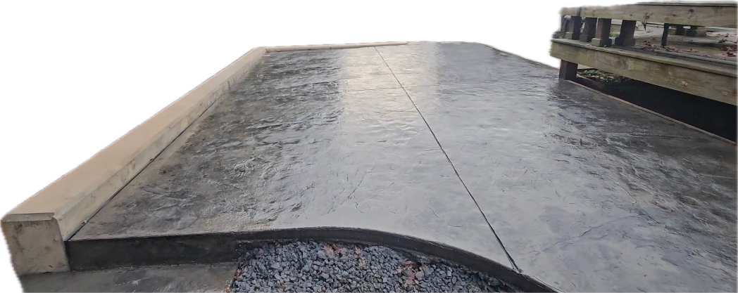 Charcoal stamped concrete patio with a smooth curved border
